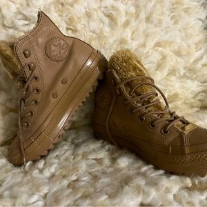 Woman’s leather Converse for rain or snow.
